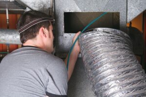 A person is doing duct cleaning