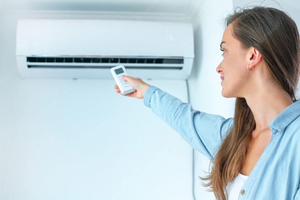 AC in the room and girl with AC remote