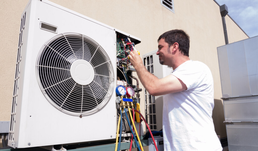 A Person is installing Ductless Air Conditioner