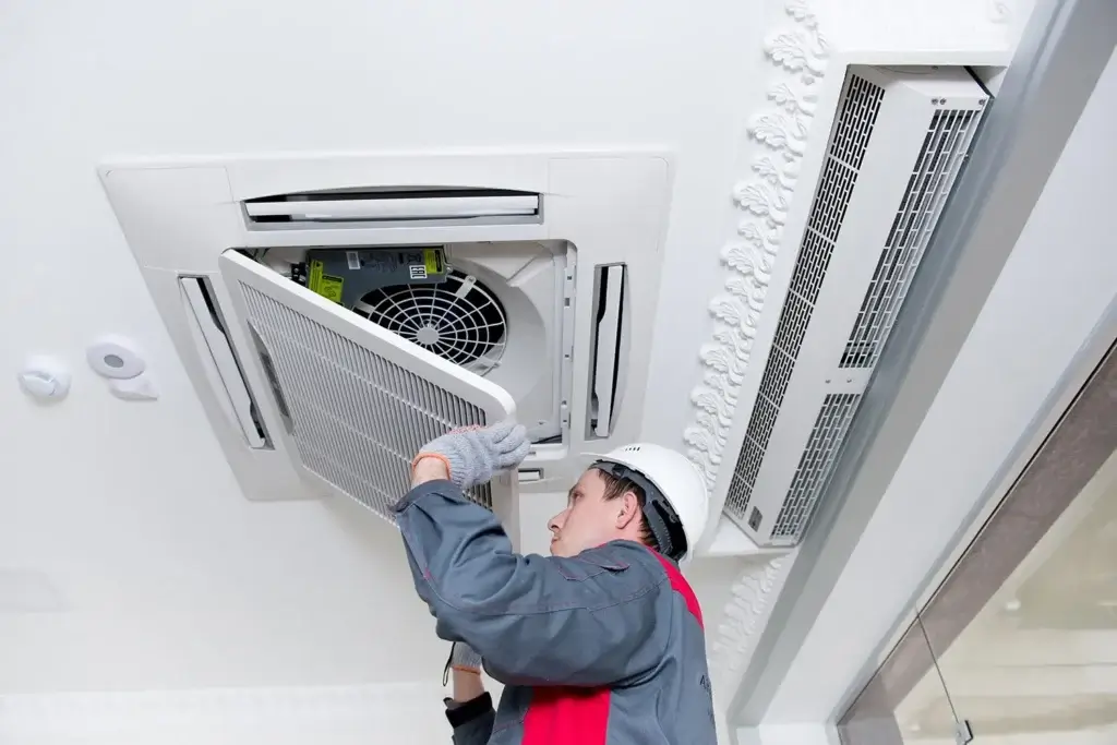 A person is installing central AC
