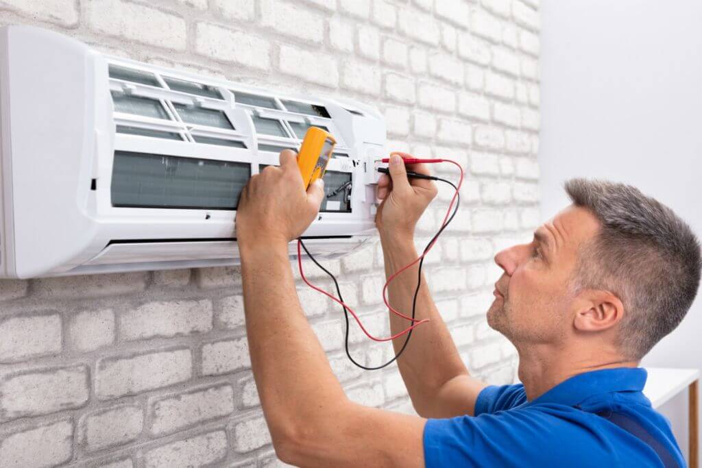An air conditioner repairman troubleshoot your air conditioner